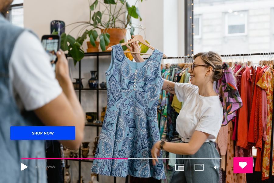 lady showcasing a dress in front of a camera during a live shopping session